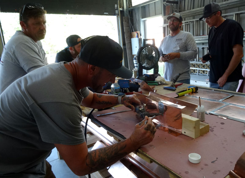 Solder copper flashings is taught at the Slate Roofing Contractors Association conference. Solder copper flashings is taught at the Slate Roofing Contractors Association conference.